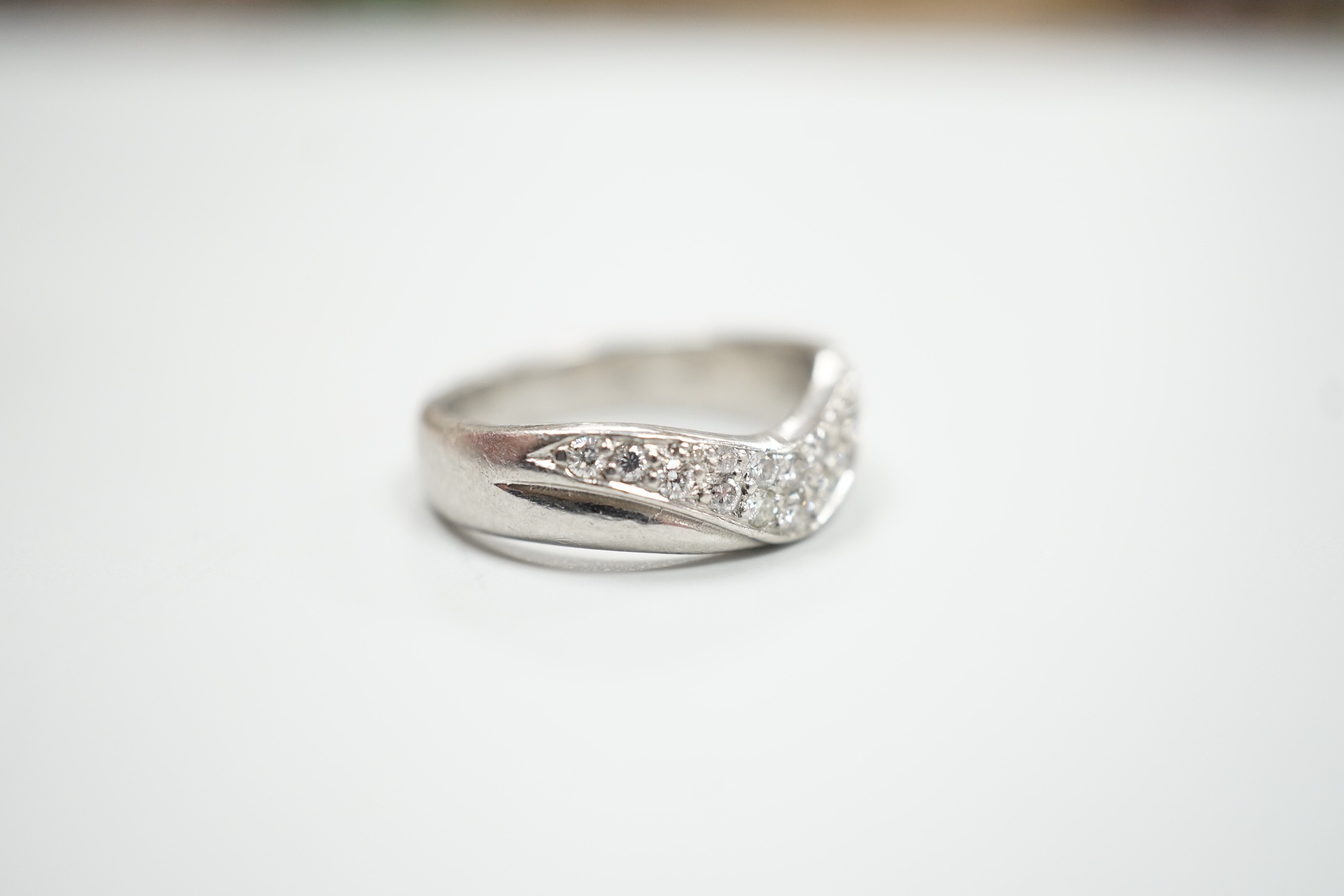 A modern platinum and diamond cluster set 'chevron' ring, size N, gross weight 9.2 grams.